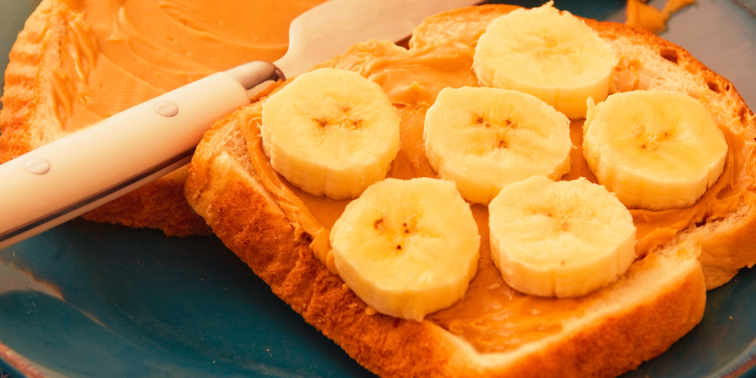 image of a slice of bread with peanut butter and sliced bananas on it as well as a banner that reads Northeast Louisiana Food Banks